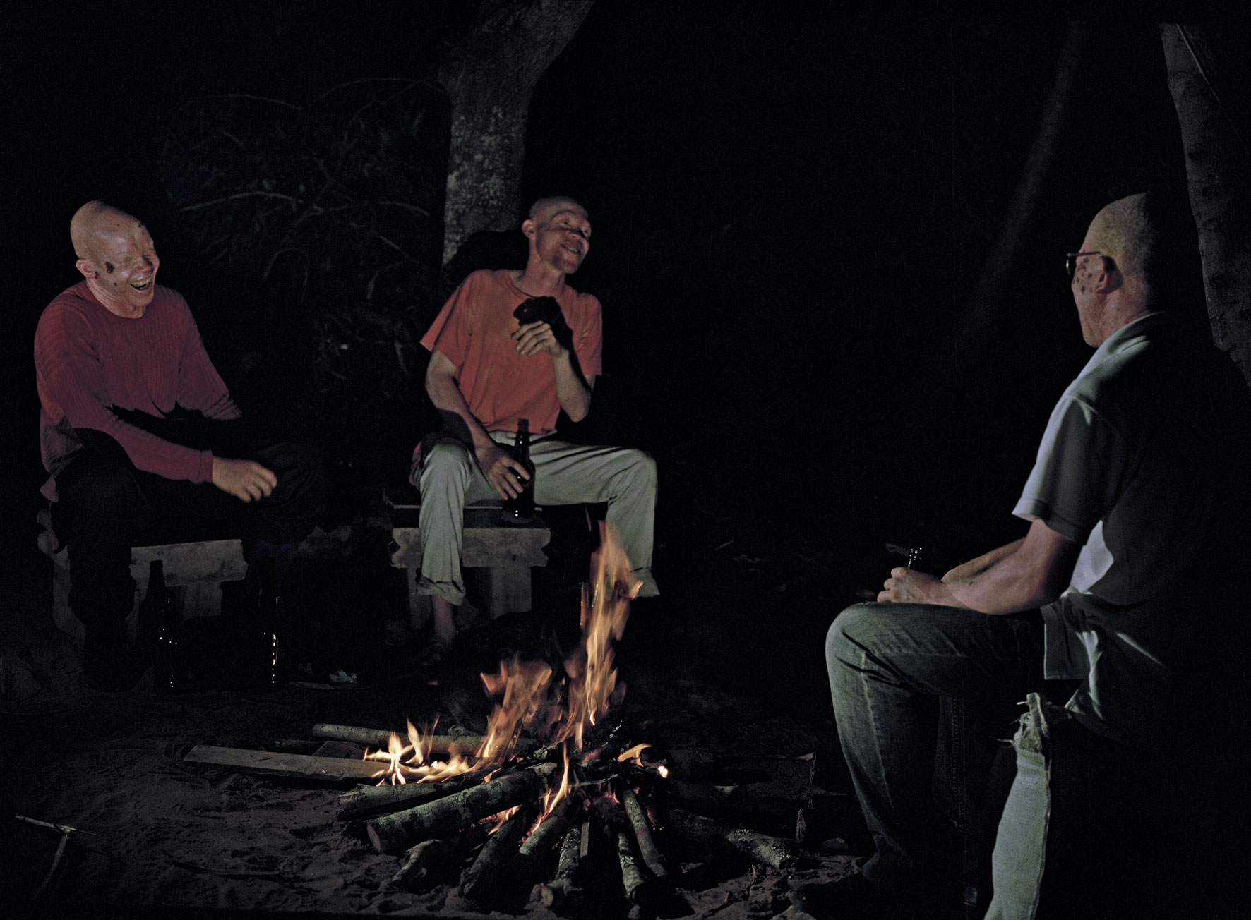 João Maria Gusmão + Pedro Paiva. Three albinos telling jokes at the fire, 2013. Chromogenic colour print, 60 x 90 cm